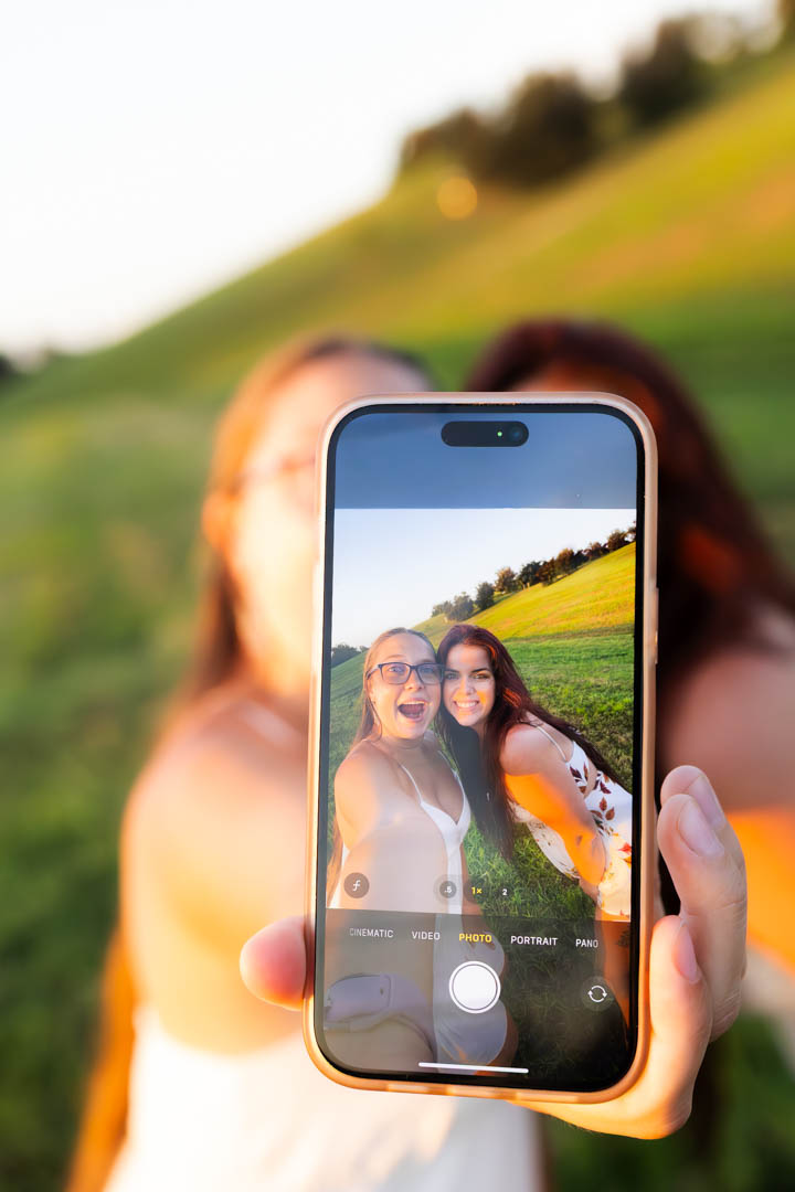 Friends crowded together looking into a phone