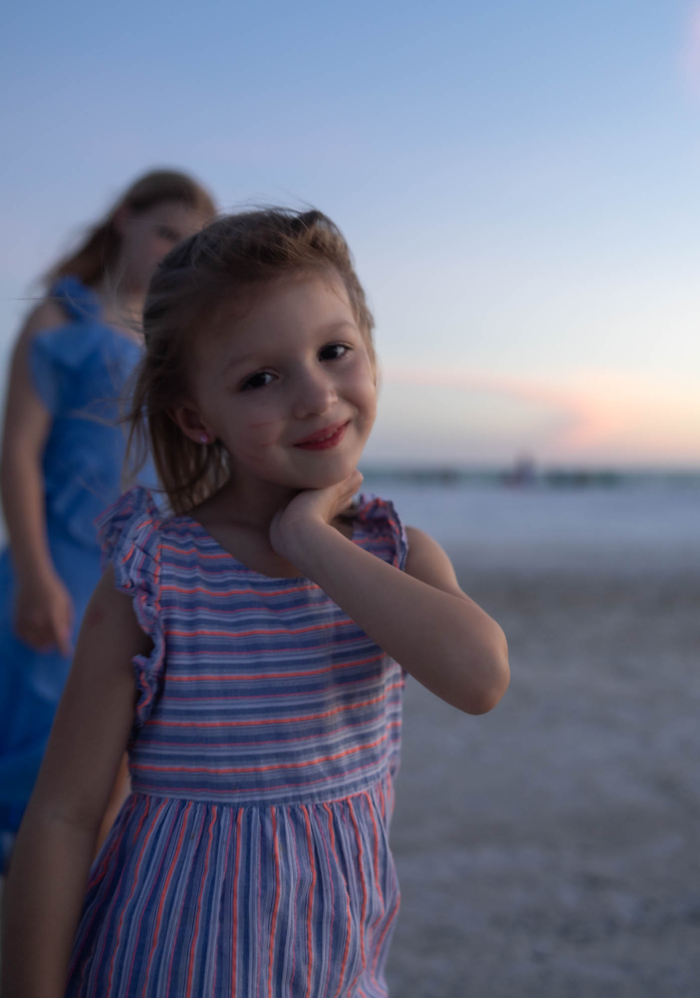 Sisters on the beach at sunset